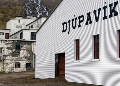 A white building with a sign on the side of it